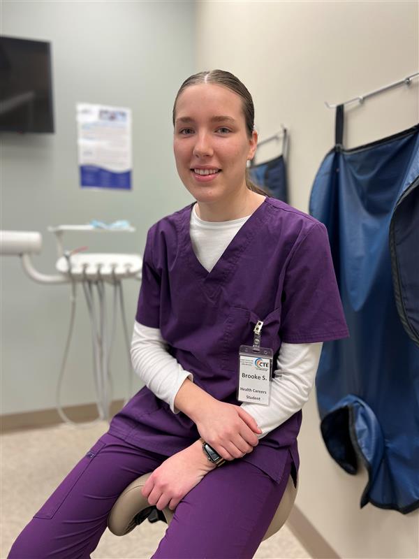 A photo of a CTE Dental Student in scrubs