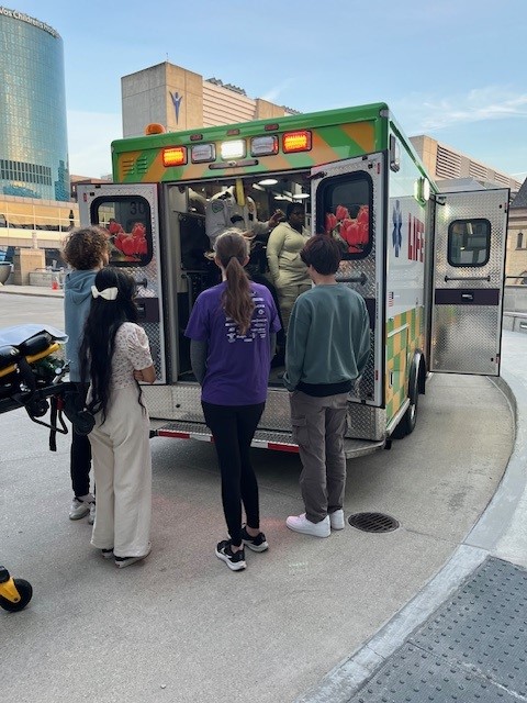 A group of students touring an ambulance