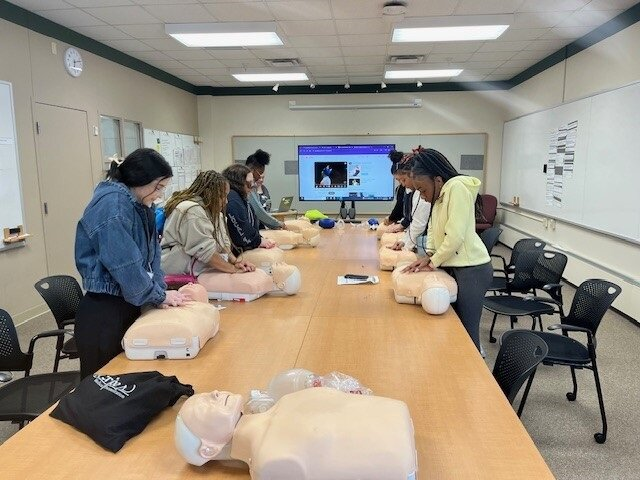 Students at All About Nursing practicing CPR on manequins