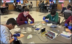 Students practicing suturing on mannequins